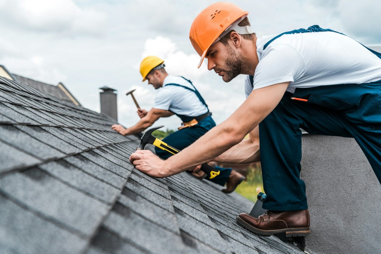 selective-focus-of-handsome-handyman-repairing-roof-with-coworker.jpg
